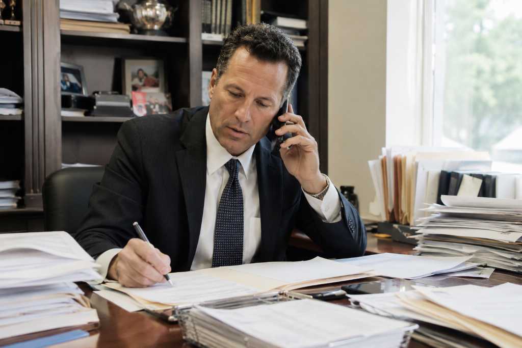 Bail Bondsman Reviewing Client Files