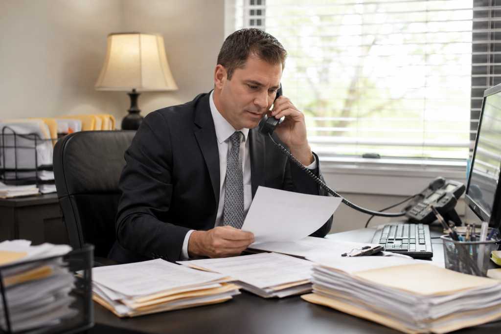 Busy Bondsman Handling Paperwork