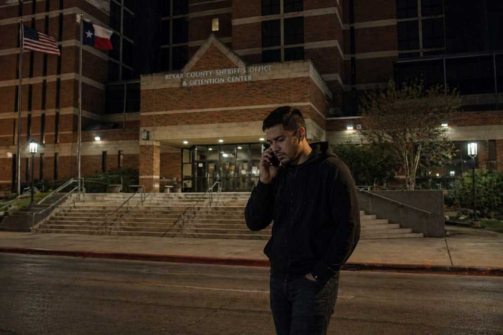 Man outside Bexar County Jail at night