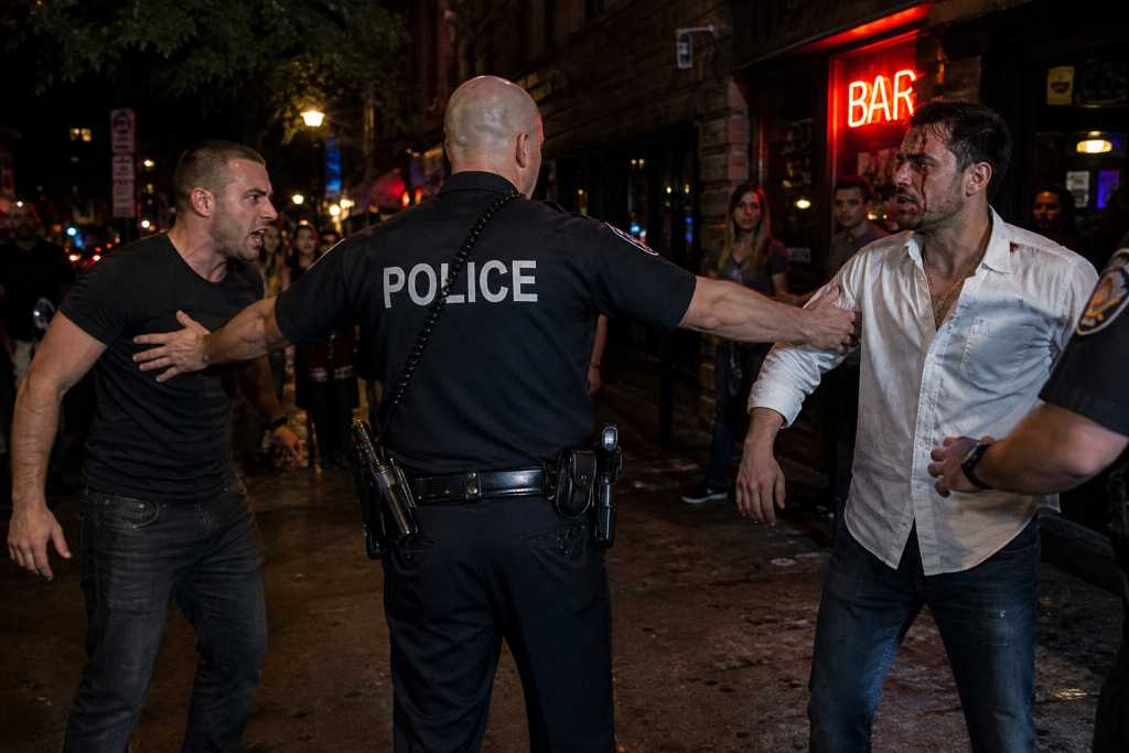 Nighttime street confrontation outside a bar