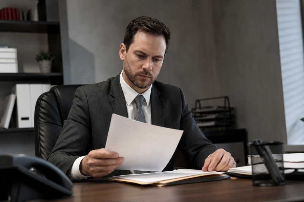 Serious Bail Bondsman Handling Client Files